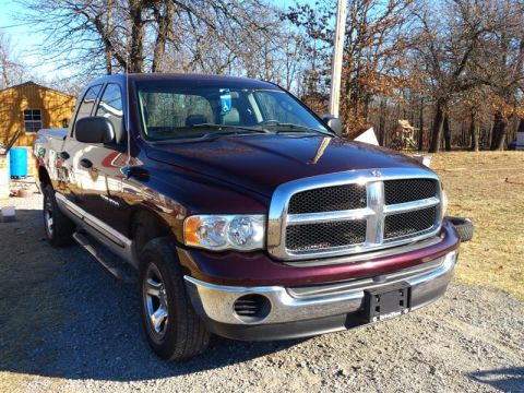 2004 Dodge 1500 - This maroon 2004 Dodge 1500 pickup truck is shown from the front three-quarter view.