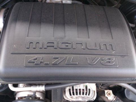 2004 Dodge 1500 - Close-up of an engine bay, showing the "MAGNUM 4.7L V8" engine cover and alternator.