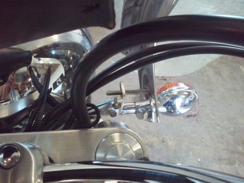 1995 Ford F-150 - A chrome motorcycle turn signal with an orange lens is visible, mounted on a black handlebar.