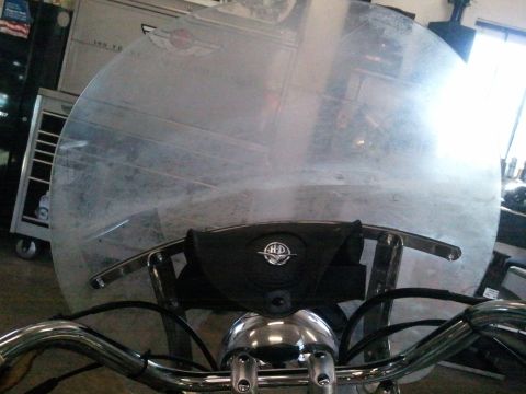 1995 Ford F-150 - A clear motorcycle windshield is shown with a black pouch bearing the Harley-Davidson logo.