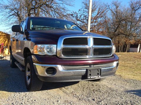 2004 Dodge 1500 - Maroon Dodge Ram pickup truck from the front-right, showing its grille and headlights.