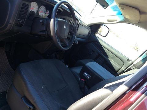 2004 Dodge 1500 - Interior view of a truck, showing the dashboard, steering wheel, and seats.