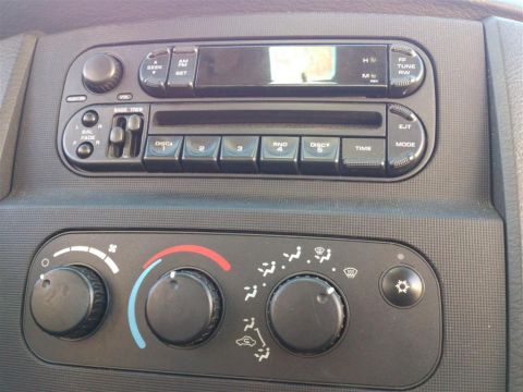 2004 Dodge 1500 - Close-up of the car's radio and HVAC controls, showing the knobs and buttons for temperature and fan speed.