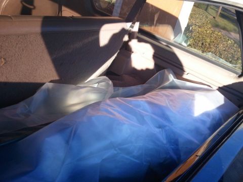 1994 Ford Bronco - Items covered in plastic inside the cargo area of a vehicle.