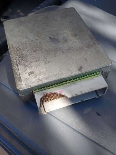 1994 Ford Bronco - Close-up of an engine control unit (ECU) showing its connector and pins.