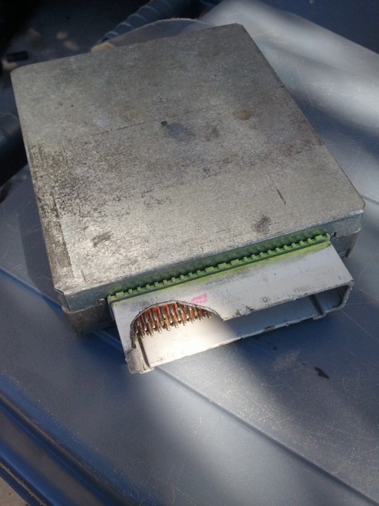 Engine control unit with green connector and exposed pins