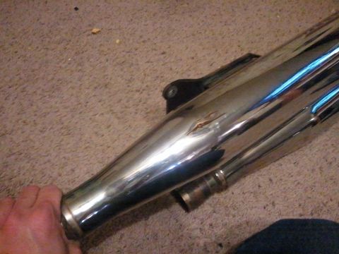 1995 Ford F-150 - A chrome exhaust pipe, likely from a motorcycle, is shown close-up.
