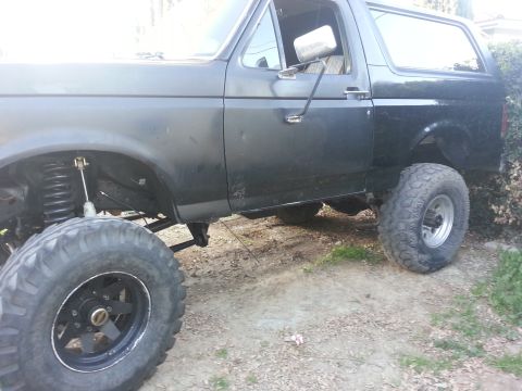 1978 Ford Bronco - This lifted SUV has oversized tires and visible suspension modifications.
