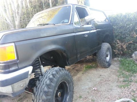 1978 Ford Bronco - This modified Ford Bronco features a lifted suspension and oversized tires, indicating off-road capabilities.