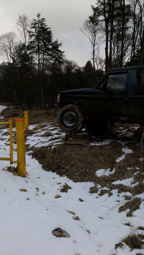 1995 Ford Bronco - 1995 Ford Bronco navigating snowy, off-road conditions.
