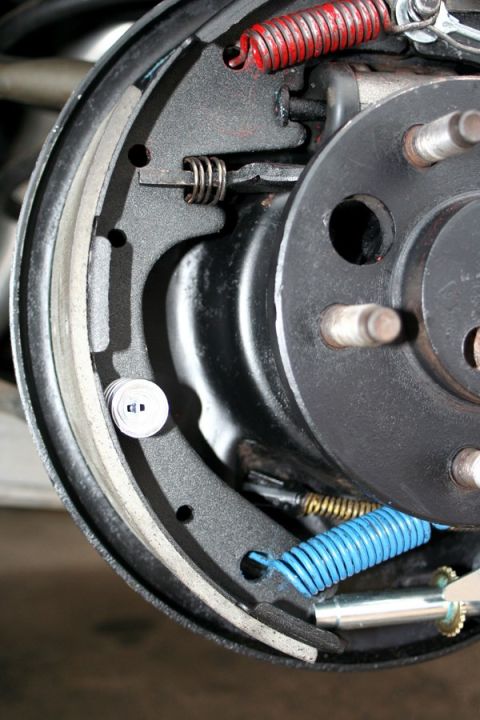 1976 Ford Ranchero - Detail of a vehicle's internal brake drum mechanism, showing brake shoes and springs.