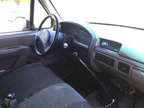 1992 Ford Bronco - The interior of a truck shows the driver's side seat, steering wheel, and dashboard area.