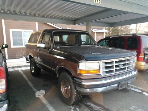 1992 Ford Bronco - This 1992 Ford Bronco is parked under a carport next to another vehicle.
