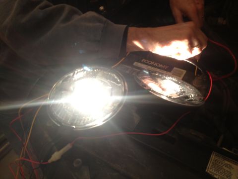 1996 Ford Bronco - A headlight assembly is shown with electrical wiring connected.