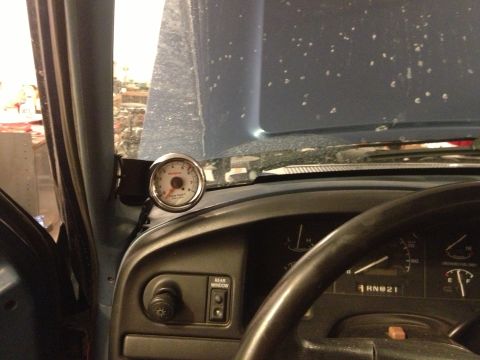 1996 Ford Bronco - An aftermarket gauge is installed on the dashboard of a vehicle.