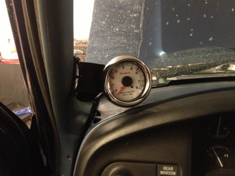 1996 Ford Bronco - Sunpro Super Tach II tachometer gauge is visible inside a vehicle's interior.