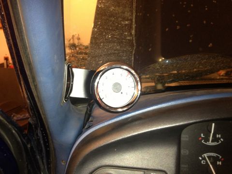 1996 Ford Bronco - A gauge is mounted on the interior A-pillar of a vehicle, with part of the dashboard visible.