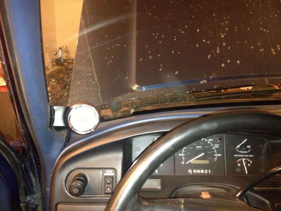 1996 Ford Bronco dashboard with a gauge mounted on the A-pillar and a steering wheel