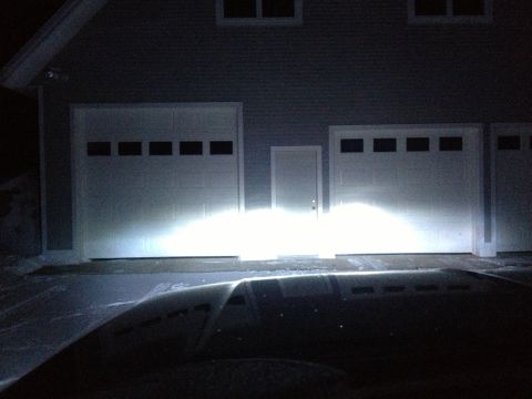 1996 Ford Bronco - Headlights illuminate a garage door at night, with a Supermotors.net logo in the corner.