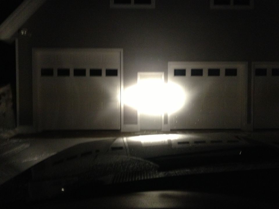 vehicle headlights shining on garage doors