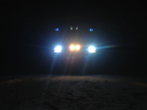 1996 Ford Bronco - A 1992 Ford Bronco's front end is illuminated by its headlights and additional lights in the dark.