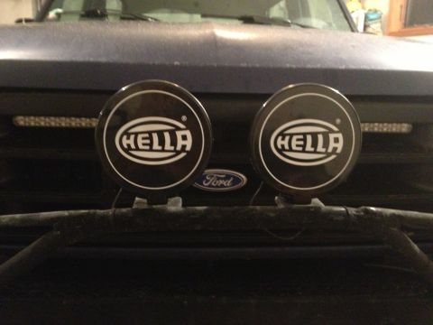 1996 Ford Bronco - The front of a Ford Bronco is visible, two round Hella lights and a Ford emblem.
