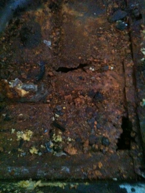 1975 Ford Ranchero - The interior floor pan is heavily rusted and shows significant damage.