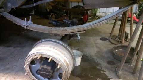 1995 Ford Bronco - Vehicle's leaf spring and wheel hub assembly are visible, suggesting maintenance or repair work.