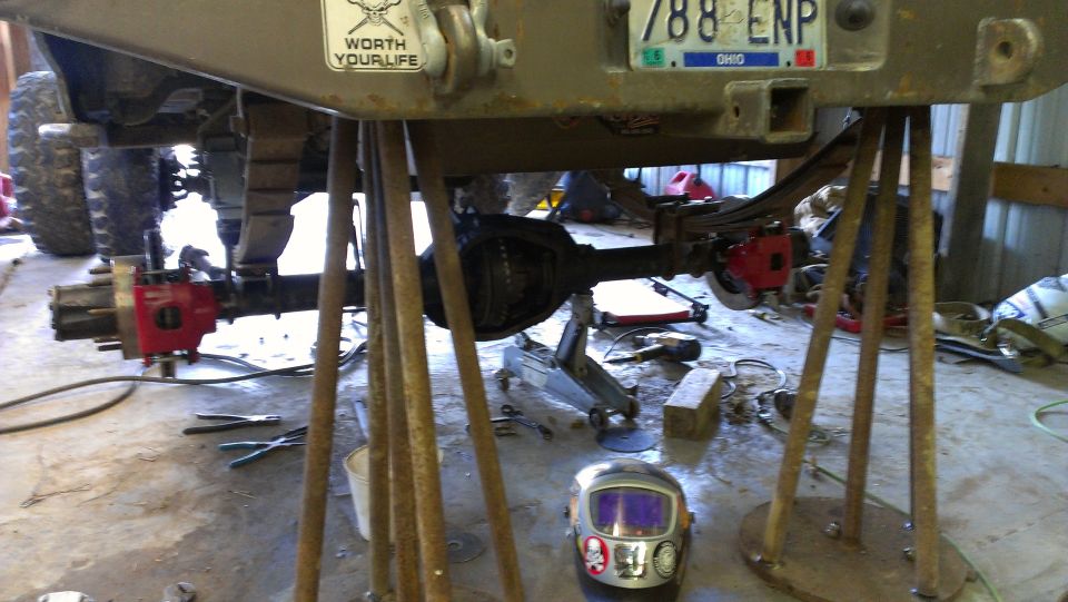 1995 Ford Bronco rear axle and suspension on jack stands with "Worth Your Life" sticker