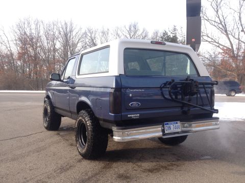 1996 Ford Bronco - This 1996 Ford Bronco is shown from the rear with a spare tire carrier mounted on the tailgate.