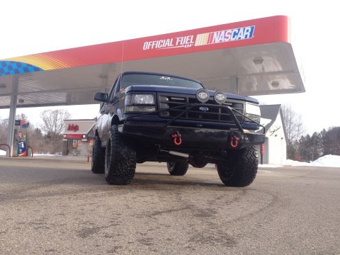 1996 Ford Bronco - This modified Ford Bronco is seen at a gas station with a "Official Fuel of NASCAR" sign overhead.