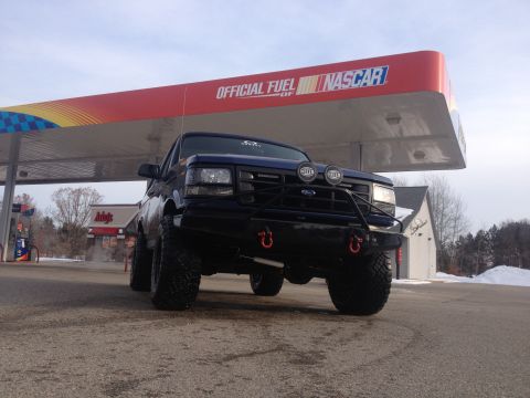 1996 Ford Bronco - This 1996 Ford Bronco is parked at a gas station under a NASCAR-branded awning.