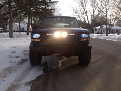 1996 Ford Bronco - This 1996 Ford Bronco features an aftermarket bumper and auxiliary lighting, seen from the front in a snowy setting.