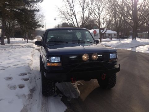 1996 Ford Bronco - 1996 Ford Bronco parked on a snowy road, an aftermarket bumper and lights.