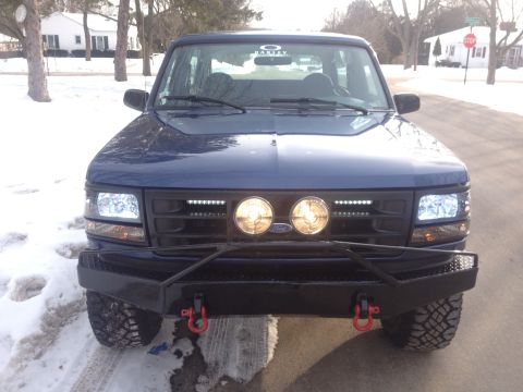 1996 Ford Bronco - This 1996 Ford Bronco features an aftermarket bumper and auxiliary lights, seen here in a front-facing view.