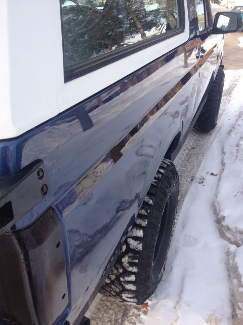 1996 Ford Bronco - This Ford Bronco is seen from the side, with snow on the ground and tires.