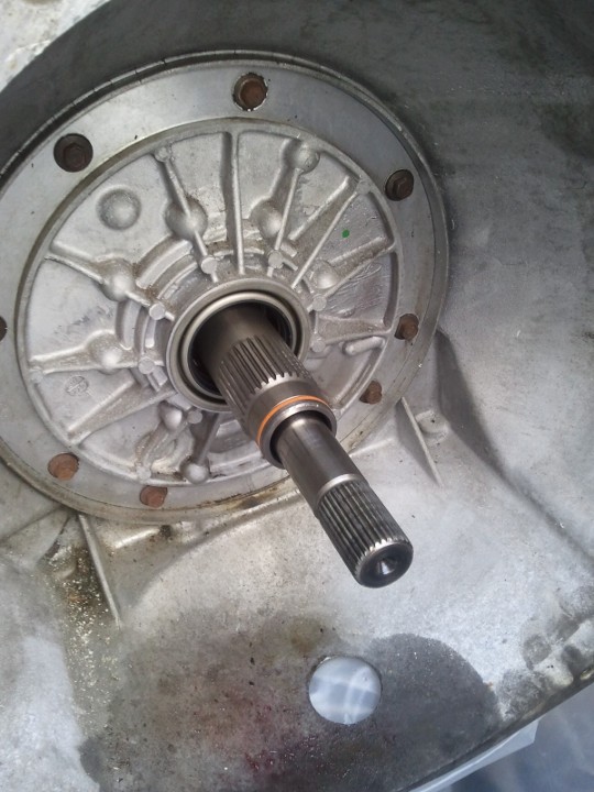 Transmission pump assembly with splined input shaft. Metal casing shows wear and some fluid residue