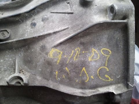 1994 Ford Bronco - A close-up view of a transmission housing with handwritten yellow markings.
