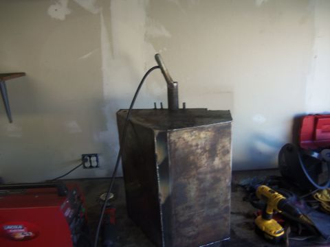 1968 Ford Bronco - A fabricated metal fuel tank sits in a workshop, possibly awaiting installation or modification.
