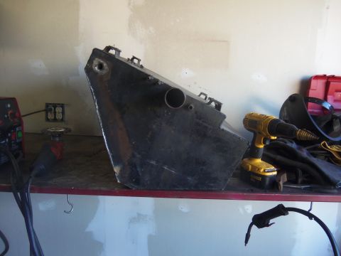 1968 Ford Bronco - Metal fuel tank on a shelf with tools, possibly for a modification project.