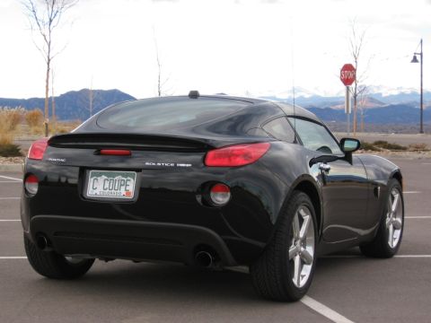 1995 Ford Bronco - Rear view of a black Pontiac Solstice GXP Coupe with a custom Colorado license plate.