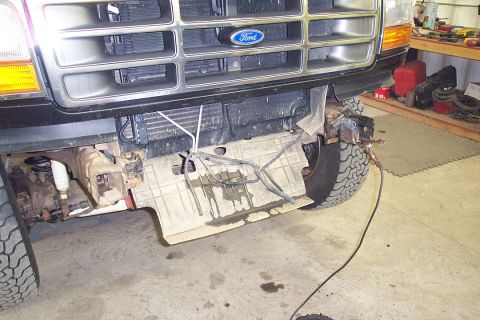 1996 Ford Bronco - Front view of a 1996 Ford Bronco with the grille and bumper removed, revealing the radiator and suspension.