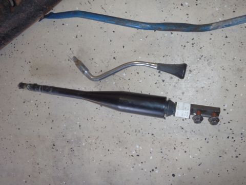 1978 Ford Bronco - Automotive parts laid out on a concrete floor, with a blue bar in the background.