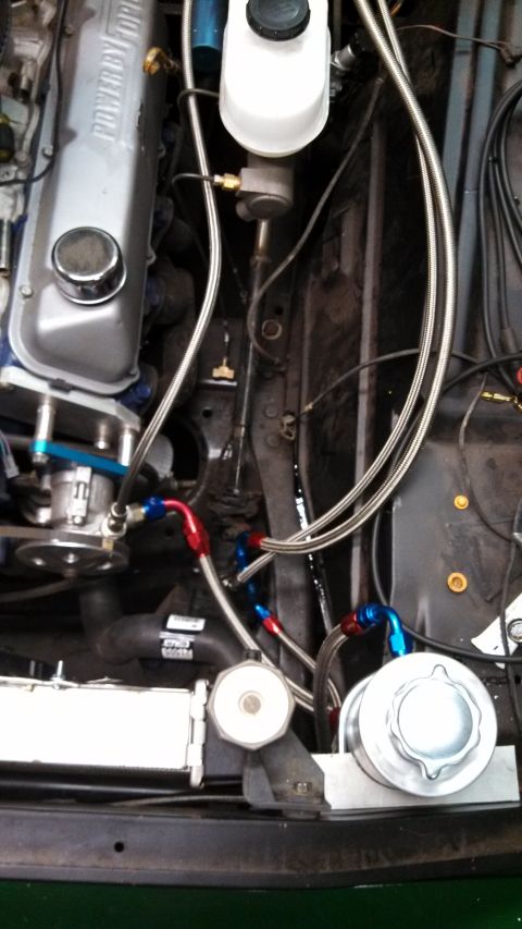 1967 Ford F-250 - Custom fuel lines installed in an engine bay, a Ford valve cover and brake fluid reservoir.