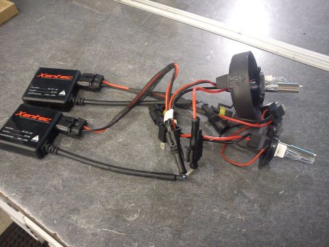 1998 Toyota Camry - A Xentec HID ballast and bulb kit is laid out on a workbench, showing the wiring and components.