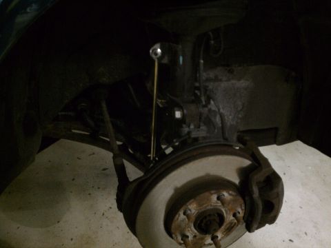 1998 Toyota Camry - Close-up view of a vehicle's front suspension and brake system.