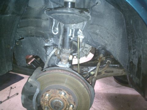 1998 Toyota Camry - Close-up view of the front suspension and brake components of a 1998 Toyota Camry.