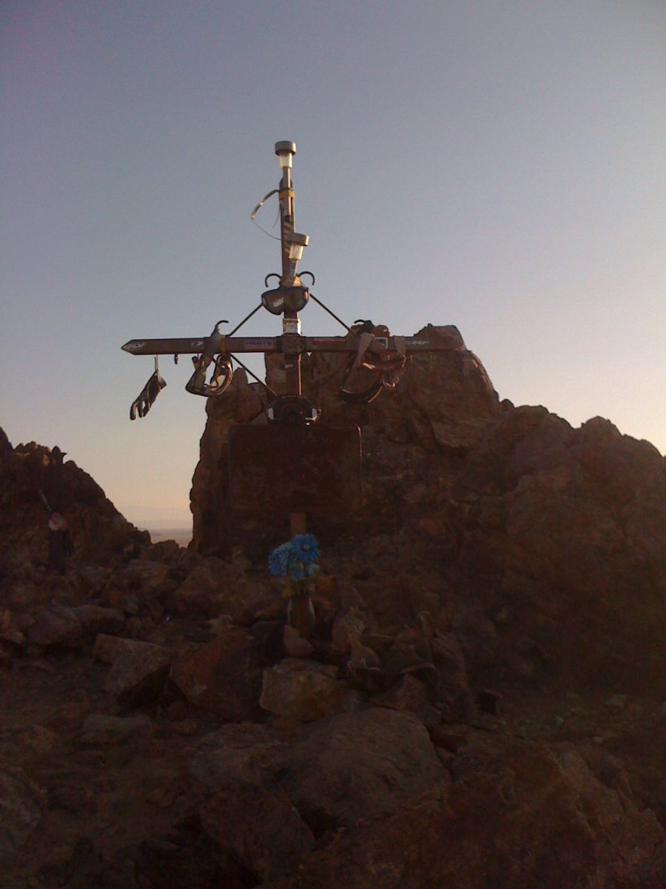 Summit cross on rocky peak against clear sky