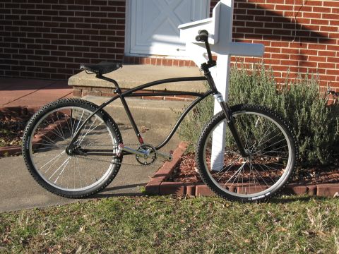 1994 Ford Bronco - A custom cruiser bicycle with a unique frame design sits outside a brick house.