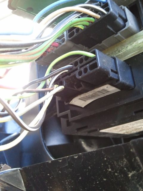 1994 Ford Bronco - A close-up view of a vehicle's electrical wiring harness and connectors.
